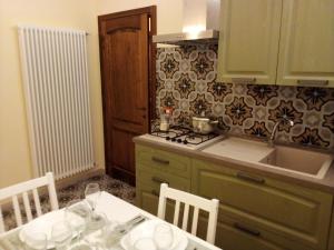 a kitchen with a table and a sink and a stove at volterracentro in Volterra +85 photos