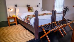 a bedroom with a bed with a wooden frame at Maksoru Spring Lodge in Arusha