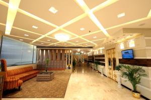a lobby with couches and a television in a building at Park Ocean in Jaipur