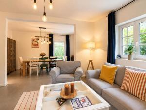 a living room with a couch and a table at Wellness Chalet Luby in Luby