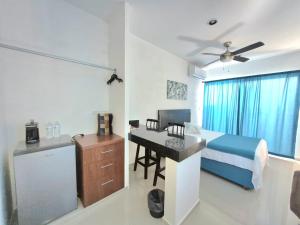a bedroom with a bed and a desk in it at Casa Terracota Micro Hotel Consulado in Mérida