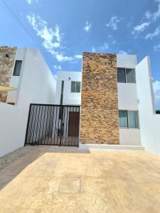 a building with a gate in front of it at Casa Terracota Micro Hotel Consulado in Mérida