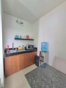 a kitchen with a sink and a microwave at Casa Terracota Micro Hotel Consulado in Mérida +16 photos