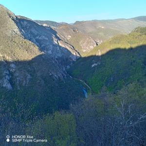 a view of a valley in the mountains at Djedova koliba in Žabljak