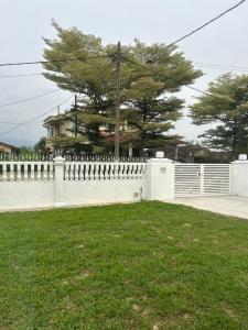 a white fence in front of a house at Haus176 in Bentong +5 photos
