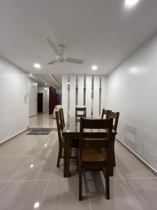 a dining room with a table and chairs and a ceiling fan at Haus176 in Bentong