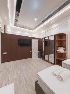 a large room with a bed and a flat screen tv at As-Mira Hotel in Samarkand +30 photos