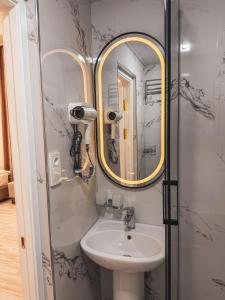 a bathroom with a sink and a mirror at As-Mira Hotel in Samarkand