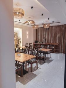 a dining room with wooden tables and chairs at As-Mira Hotel in Samarkand