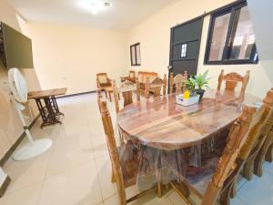 a dining room with a wooden table and chairs at Guadalupe House Esquipulas in Esquipulas