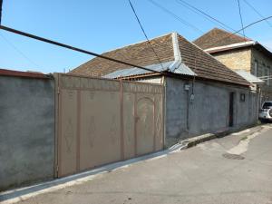 a building with a gate in front of a house at happy star stay in Sheki