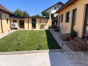 a backyard with a lawn with golf balls in it at CAZARE JASMINA in Corbu