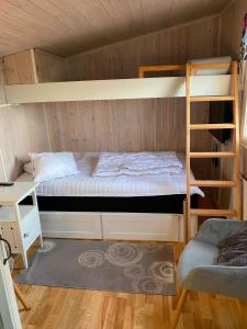 a bedroom with two bunk beds and a desk at Havsutsikt in Ronneby