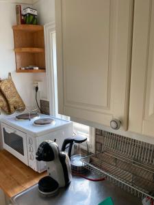a kitchen with a appliance on the counter next to a stove at Havsutsikt in Ronneby