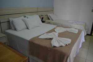 Postel nebo postele na pokoji v ubytování Esplendor Palace Hotel