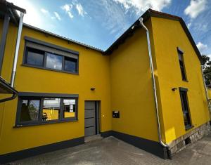 a yellow house with a garage at Ferienhaus Rimpar in Rimpar
