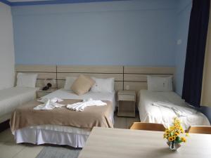 Postel nebo postele na pokoji v ubytování Esplendor Palace Hotel