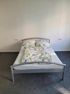 a bed in a room with a bed frame and pillows at Simple Übernachtungsmöglichkeit in Krumbach