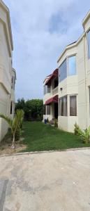 a large white building with a palm tree in front of it at Parinay Pavilion LLP in Bahraich