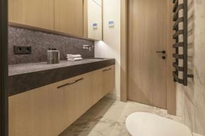 a bathroom with a sink and a toilet at Vilnius Apartments & Suites – Old Town in Vilnius