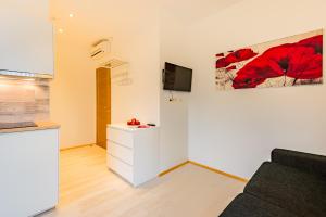a living room with a couch and a tv at Riga Airport Jurmala apartments in Rīga