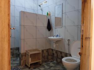 a bathroom with a toilet and a sink at Rumah Kawan Homestay and Trekking in Senaru +74 photos