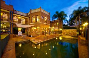 a large house with a swimming pool in front of it at Albury Paddlesteamer in Albury