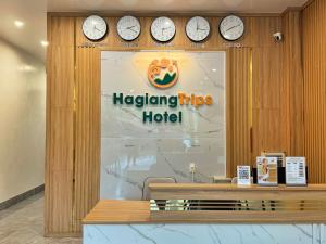 a hotel lobby with clocks on the wall at HagiangTrips Hotel in Ha Giang