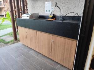 a kitchen with a sink and a counter at Naay Villas - Flat Beira Mar - Sao Miguel dos Milagres in Pôrto de Pedras +37 photos