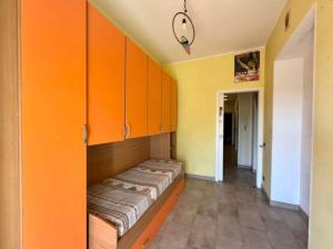 a room with orange cabinets and a bed in it at Alloggio turistico Brancaleone in Genazzano