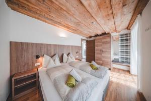 a bedroom with a large bed with white sheets and yellow pillows at Historic Residence Barbara in Colle Isarco +78 photos