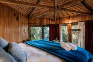 a bedroom with a large bed in a room with windows at Ora Retreat in Queenstown +145 photos