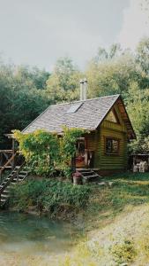 a log cabin on the side of a river at Härjamäe Saunamaja 