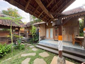 an outside view of a house with a patio at Arta Wooden House in Sukawati