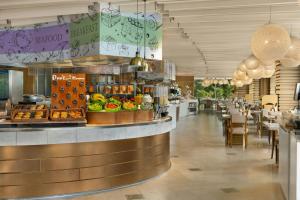 a restaurant with a counter with food on it at Sheraton Grand Beijing Dongcheng Hotel in Beijing