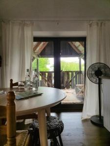 a dining room with a table and a large window at Siedlisko Po Kolei - blisko Kazimierza Dolnego in Głusko Duże