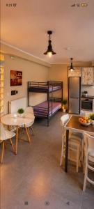 a living room with a table and a bunk bed at Vasiliki apartment in Kalamata