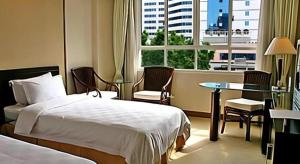 a hotel room with a bed and a table and a window at Hedong Hotel in Shenzhen +181 photos