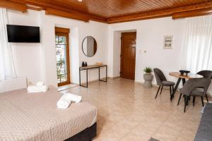a bedroom with a bed and a table and chairs at Calithera in Samothraki