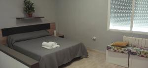 a bedroom with a bed with a white towel on it at Duna Hollidays in Puerto de Sagunto