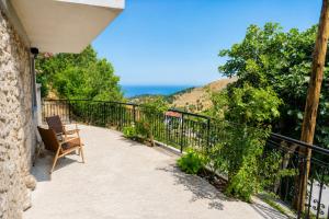 a balcony with a chair and a view of the ocean at Calithera in Samothraki