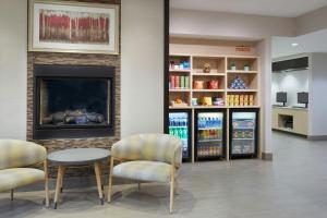 a waiting room with two chairs and a fireplace at TownePlace Suites by Marriott Thunder Bay in Thunder Bay