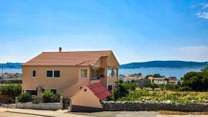 a house with a view of the water at Mendy Sea View Apartment in Kaštela