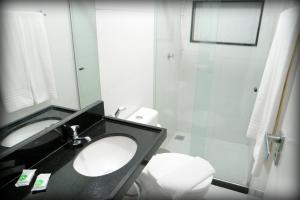 a bathroom with a sink and a toilet and a shower at Suites Residence in Recife