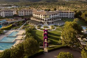 an aerial view of a resort with a pool at The St. Regis Mardavall Mallorca Resort in Portals Nous