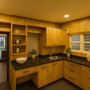 a kitchen with wooden cabinets and a sink at Secret Escape Colonial Bungalow in Ooty