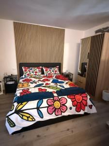 a bedroom with a bed with a floweridered blanket at Casa Belvedere in Serradica +12 photos