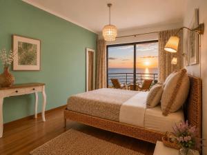 a bedroom with a bed and a view of the ocean at MyOcean Luxury l Huge Panoramic Sea View Balcony & Private Garage in Portimão