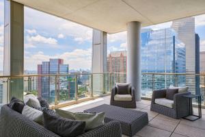 a balcony with couches and chairs and a view of the city at Marriott Marquis Houston in Houston