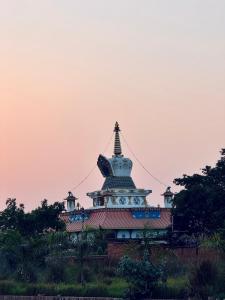 a building with a pagoda on top of it at Hotel Buddha Palace in Rummindei